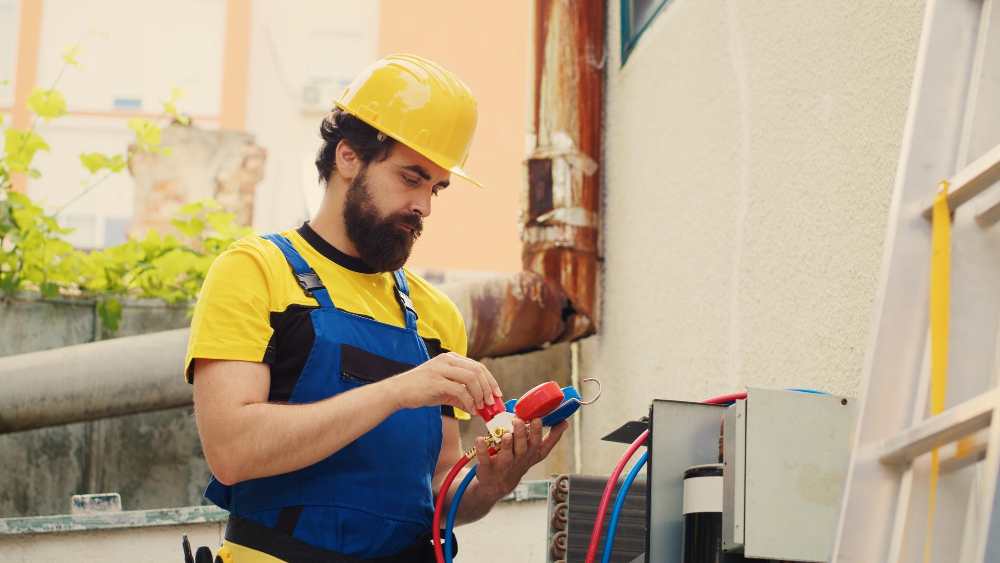 An HVAC technician overseeing a tankless water heater installation.